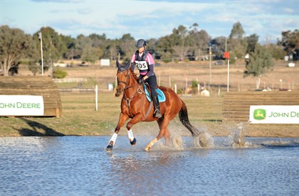 A competitor through the water jump at the 2017 event. © OzShotz