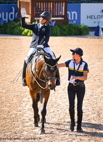 Emma Booth gives her fans a wave as she leaves the arena after her freestyle test on Mogelvangs Zidane